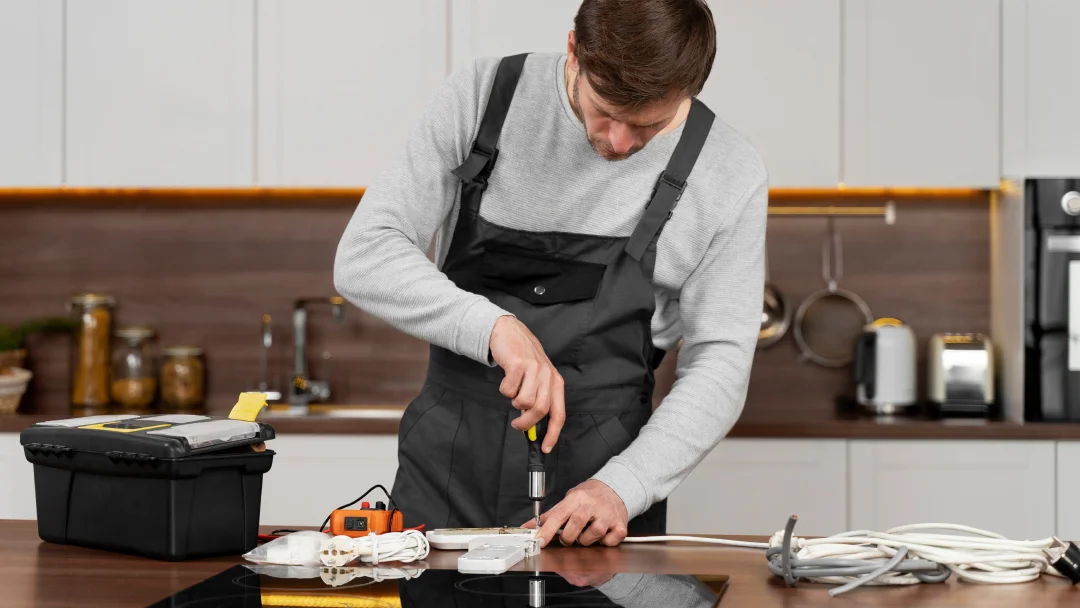 A man in an apron skillfully cuts food with a knife in a kitchen setting, showcasing his role as a kitchen installer.