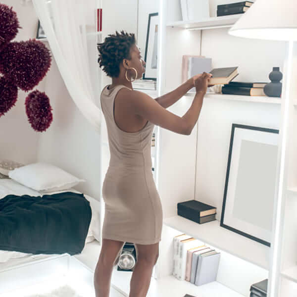 A top-down view of a perfectly tidy workspace with a laptop, a notebook, and a plant, illustrating efficient organization.