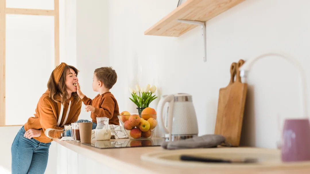 A woman and a child stand together in a modern kitchen, showcasing trends for 2026.