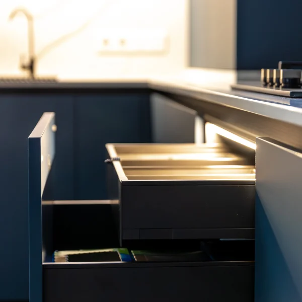 A kitchen featuring a sink and a drawer, highlighting the installation of kitchen cabinets.